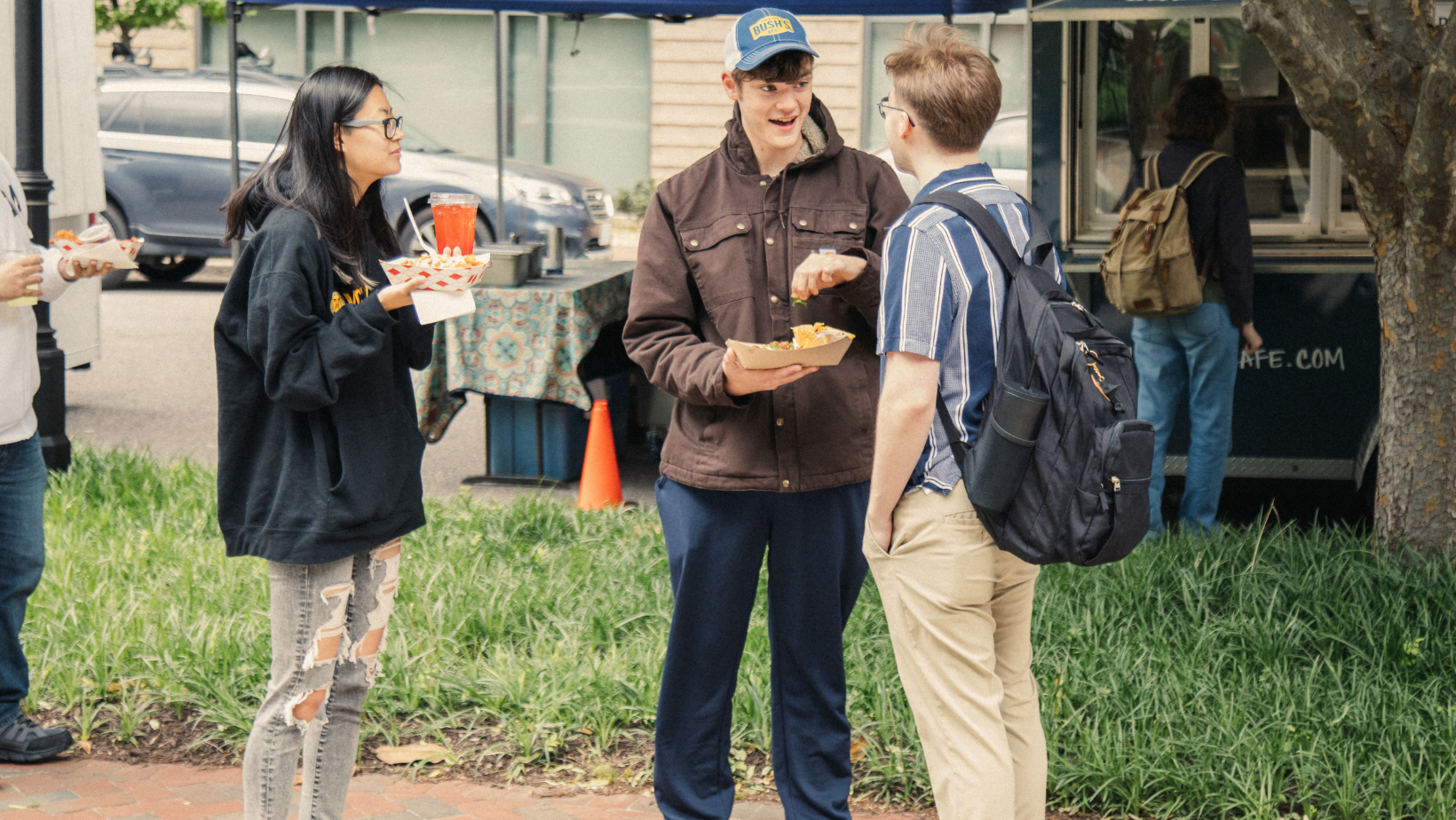 Students talking by food truck